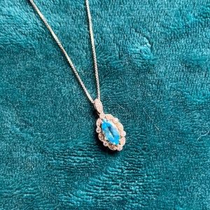 Silver chain with aquamarine stone surrounded by cz